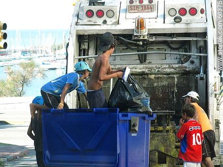 Child waste pickers in a truck of the municipality in the Rambla del Buceo -  - URUGUAY. Photo #60375