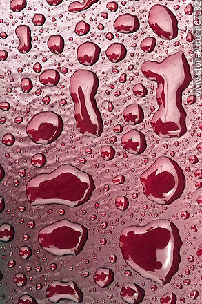 Water drops on a bright red background -  - MORE IMAGES. Photo #67082