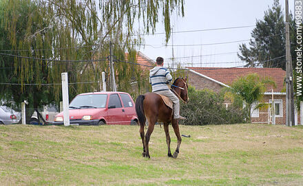 Rider on horseback near route 5 - Department of Canelones - URUGUAY. Photo #69883