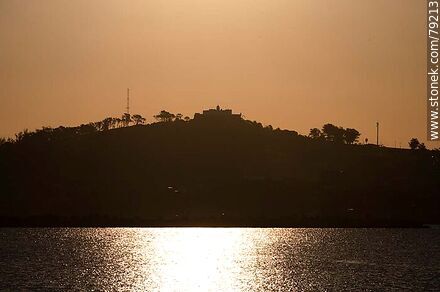 Silhouette of Cerro de Montevideo against the sun - Department of Montevideo - URUGUAY. Photo #79213