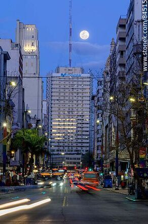 18 de Julio Avenue. Gaucho Tower. Trail of lights left by the traffic at dusk. The full moon - Department of Montevideo - URUGUAY. Photo #84515