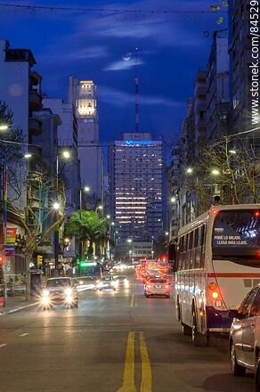 18 de Julio Avenue. Gaucho Tower. Trail of lights left by the traffic at dusk. The full moon - Department of Montevideo - URUGUAY. Photo #84529
