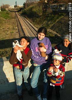 Girls with their puppies in a pedestrian bridge over the railroad. - Department of Montevideo - URUGUAY. Photo #3819